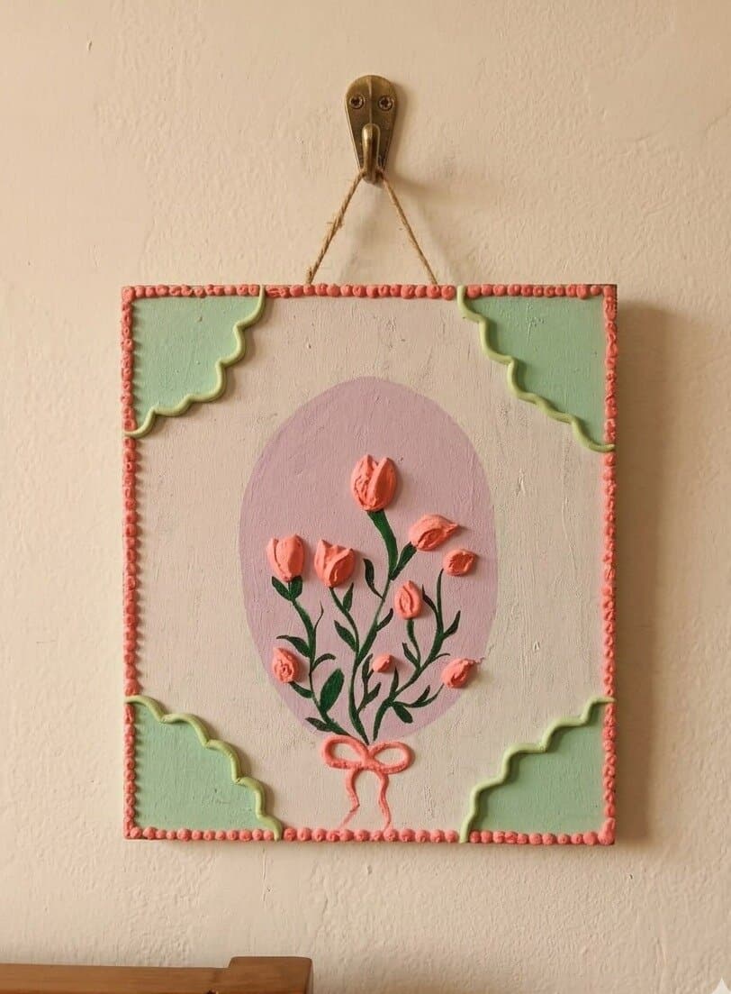 Tulip Bouquet: pink clay tulips tied with a bow on a lilac oval, with a beaded border and sage corners